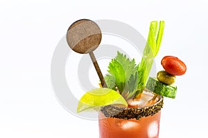 Canadian Caesar drink, typical Canadian drink, with hot sauce, celery, lemon, vodka and ice. copy space, isolated white background