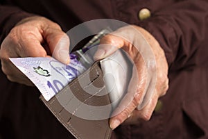 Canadian currency. Dollars. Old retired person paying in cash.