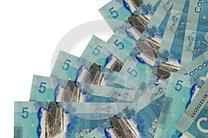 5 Canadian dollars bills lies in different order isolated on white. Local banking or money making concept photo