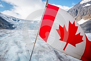 Canadian flag on Athabasca glacier in Columbia Icefield, Jasper National park, Rocky Mountains, Alberta Canada