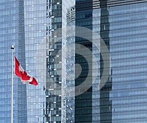 Canadian Flag flying in front glass facade office