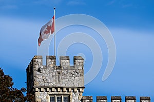 Canadian flag on Hatley Castle tower. Victoria, BC, Canada.
