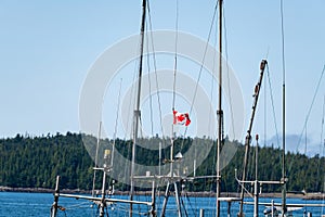 The Canadian flag on the mast of a fishing boat in Price Rupert, British Columbia, Canada