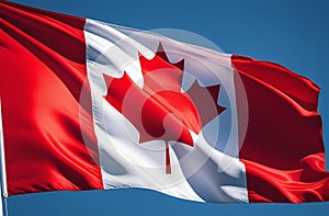 Canadian flag waving against blue sky close up. Canada day concept