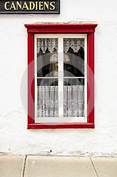 Canadian Hangout with red trimmed window sill and window panes