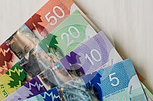 Canadian money. Dollar banknotes on wooden background