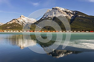 Canadian Pacific Freight Train Railway Alberta Foothills Rocky Mountains Frozen Lake Reflection Landscape