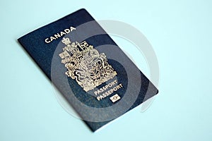Canadian passport on blue background close up