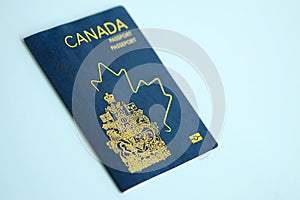 Canadian passport on blue background close up
