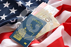 Canadian passport and money on United States national flag background