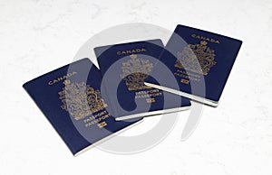 Canadian Passports on a white marble background