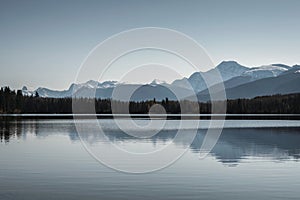 Canadian Rockies with pine forest and clear sky reflection at Pyramid lake, Jasper national park