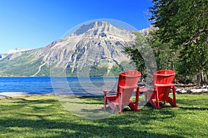 Canadian Rocky Mountains Landscape with Red Parks Canada Adirondack Chairs, Waterton Lakes National Park, Alberta