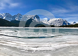 The canadian rocky mountains in winter with a frozen lake