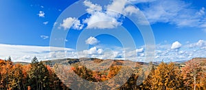 Canadian scenic Landscape with colorful forest and mountains in autumn season. Golden autumnal background with beautiful blue sky