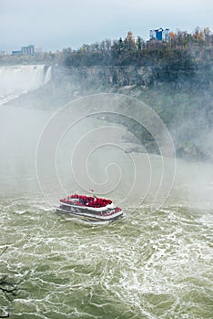 Canadian side of Niagara Falls in autumn. ship with tourists
