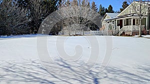 Canadian traditional family home in Canada. Panning shot in winter snow