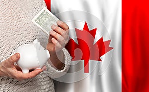 Canadian woman with money bank on the background of Canada flag. Dotations, pension fund, poverty, wealth, retirement concept