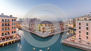 Canal aerial top view in Venice-like Qanat Quartier of the Pearl precinct of Doha day to night timelapse, Qatar.
