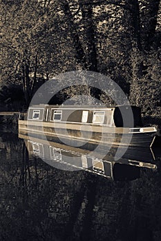 Canal barge boat moored on the Shropshire Union Canal, reflected in the water.