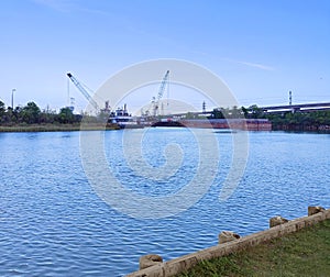 Canal barge with cranes and bridge over water