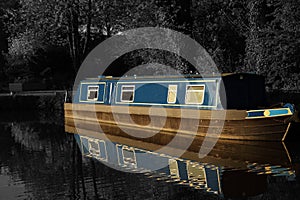 Canal barge narrow boat in water surrounded by trees