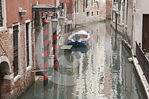 Canal with Boat and Red Brick Facade, Venice