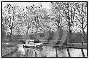 Canal boat rounding a curve on the Nivernais Canal black and white, Burgundy