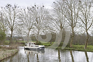 Canal boat rounding a curve on the Nivernais Canal, Burgundy