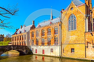 Canal, boat, tourists in Bruges, Belgium