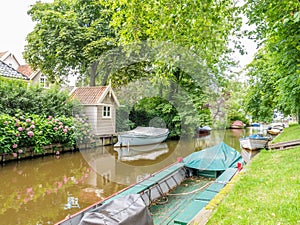 Canal with boats in old town of Broek in Waterland, Netherlands