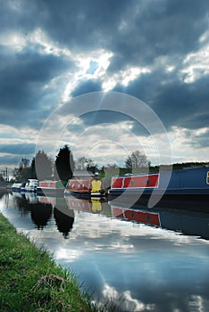 Canal boats under moody sky