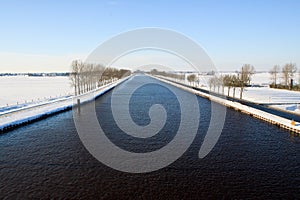 Canal in a cold white winter landscape