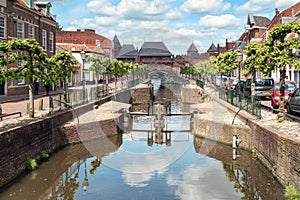 The canal Eem with in the background the medieval gate The Koppelpoort in the city of Amersfoort in The Netherlands