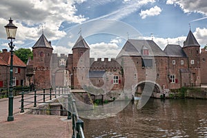 The canal Eem with in the background the medieval gate The Koppelpoort in the city of Amersfoort in The Netherlands