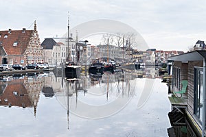 Canal  gracht  at the Old Harbour and Galgewater with traditional houses in Leiden, The Netherlands on a cloudy autumn day with photo