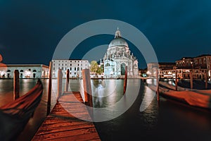 Canal Grande and Basilica di Santa Maria della Salute illuminated at dusk night time. Venice, Italy