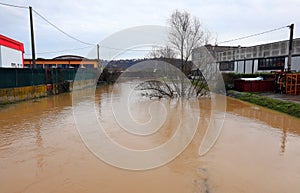 canal after heavy rains in industrial area and warehouses at risk of inundation photo