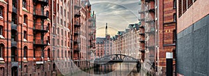 canal and historic buildings in old warehouse district Speicherstadt in Hamburg