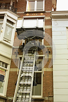 Canal house facade with a lifting machine in Holland