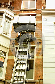 Canal house facade with a lifting machine in Holland