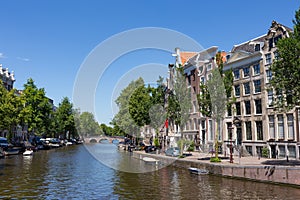 Canal houses on the Keizersgracht with a blue sky in the center of Amsterdam