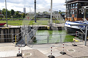 Canal lock with a barge waiting for the gate to open on the Moselle river in western Germany.