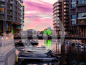 Canal with moored boats in Aker Brygge neighbourhood in Oslo, Norway.