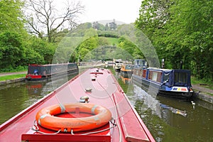 Canal narrowboat approaching historic aqueduct