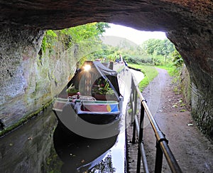 Canal narrowboat entering tunnel