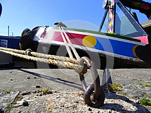 Canal narrowboat tied to a mooring ring