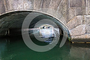 A canal passes under a bridge in Copenhagen, Denmark