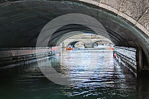 A canal passes under a bridge in Copenhagen, Denmark