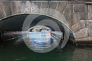 A canal passes under a bridge in Copenhagen, Denmark